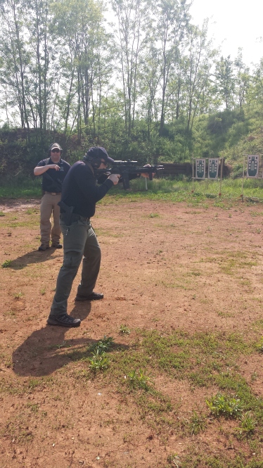 Mike demonstrates from the low ready to shooting position.